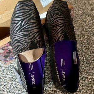 TOM’s black zebra shimmer print. Size 8 1/2 Brand new unworn, in a box